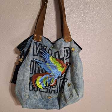 Stonewashed denim hobo bag with embroidered parrot - image 1