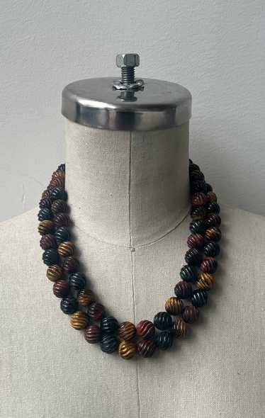 Two Strands of Black Gold and Red Tigers Eye Carve