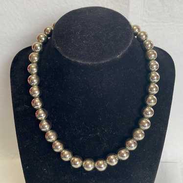 Vintage Monet silver tone bead necklace on a silve