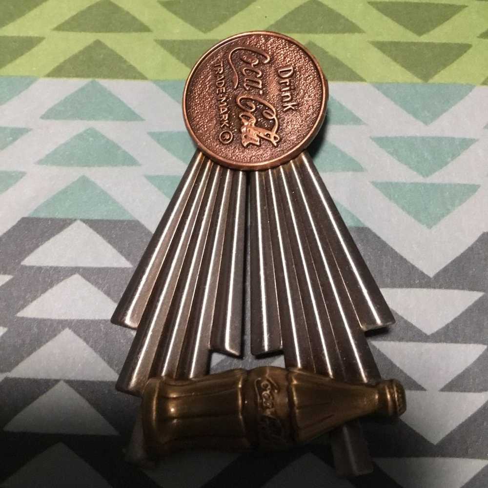 Copper colored Coca Cola pin - image 1