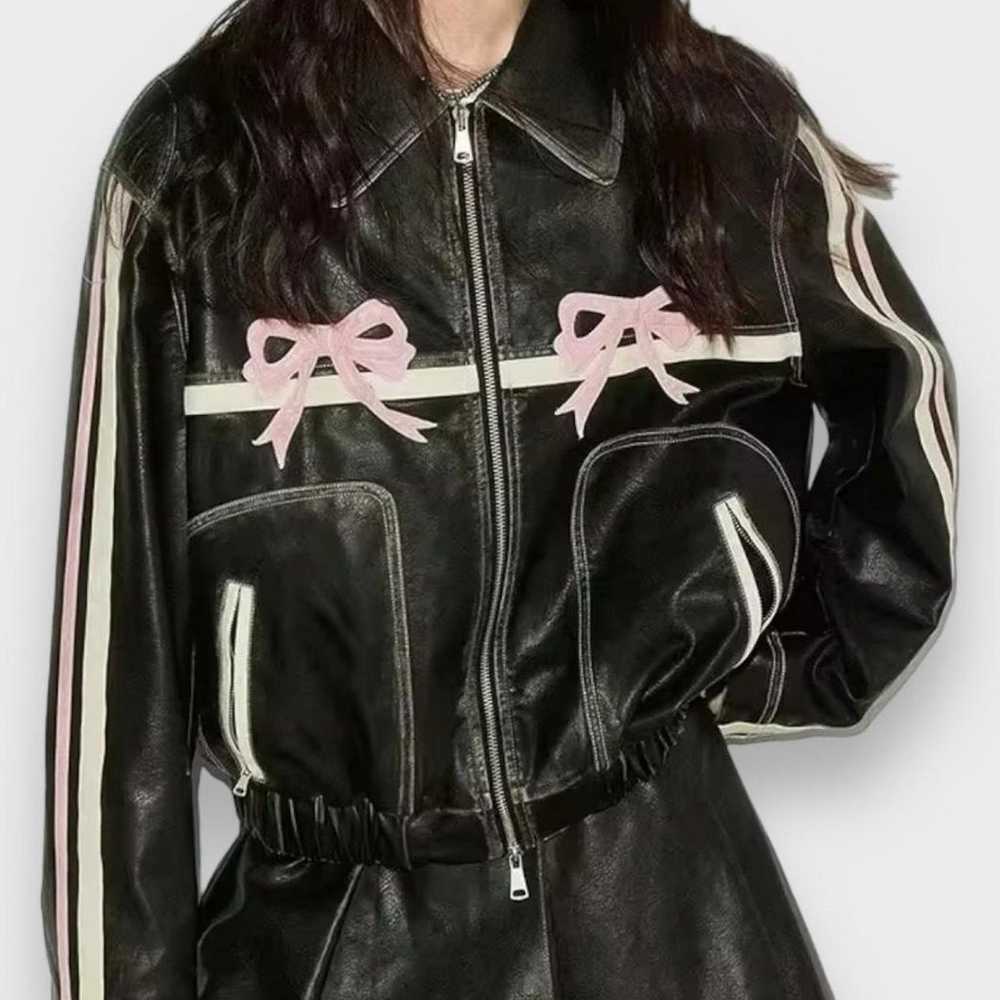 Black and pink leather jacket with a bow detail - image 1