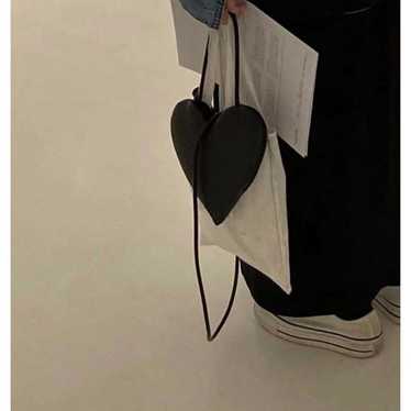 Heart-shaped shoulder bag.