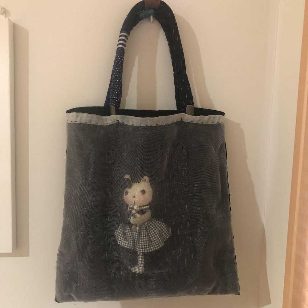 Bag with a cat doll inside - image 1