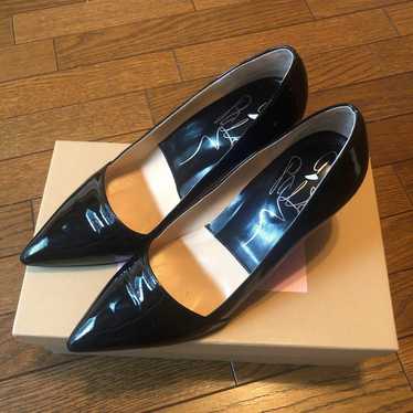 a pair of enamel black pumps