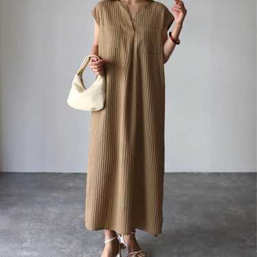 Beige sleeveless long one piece dress.