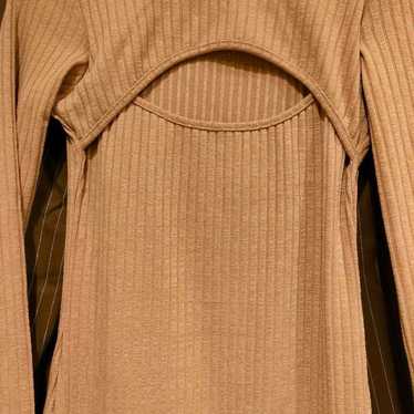 Beige ribbed open-back long-sleeve dress.