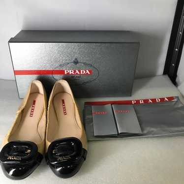 B) Prada ballet flat shoes in patent leather.