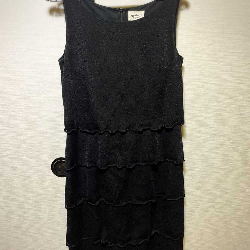 Black sleeveless dress with frill design. - image 1