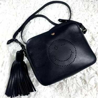 Anya Hindmarch smiley crossbody bag in black.