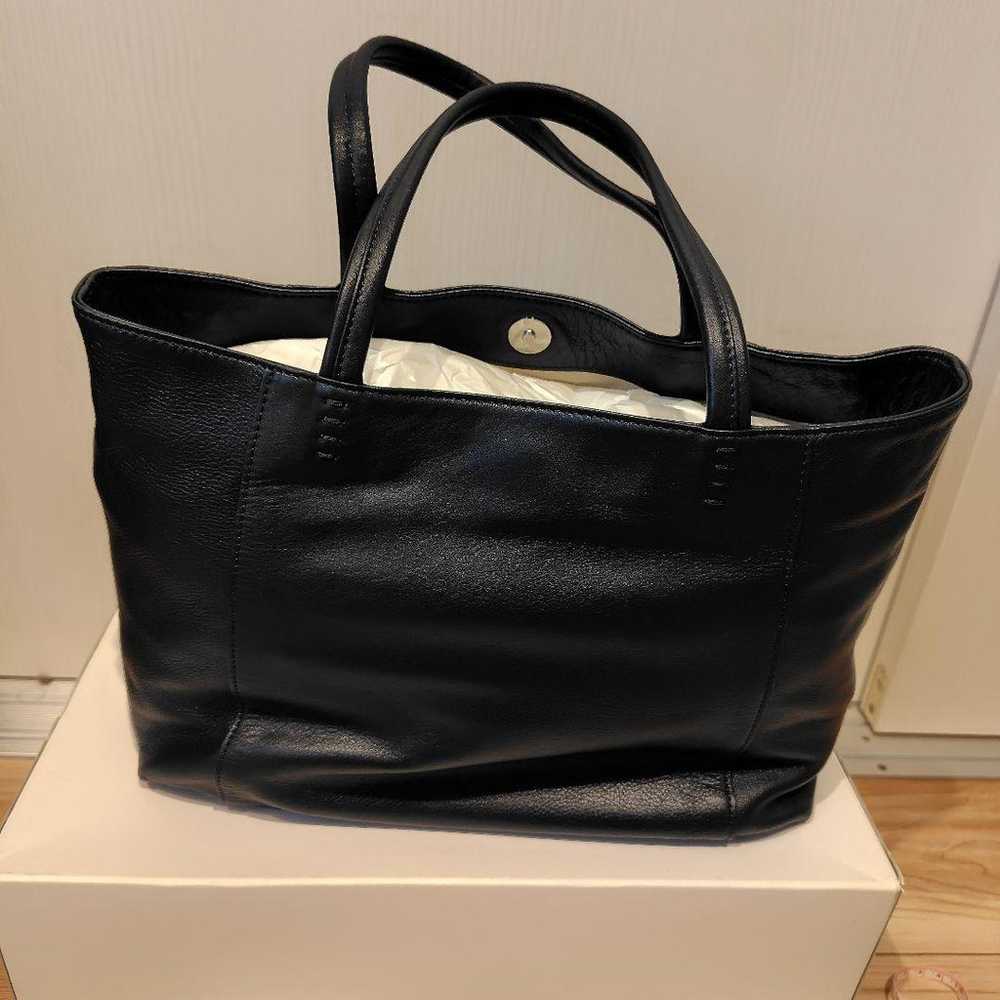 This is a navy leather tote bag from Kitamura. - image 3