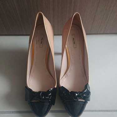 Almost new miumiu pink and black ribbon pumps.