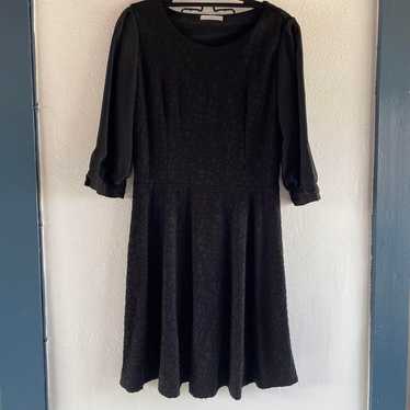 Black knee-length dress.