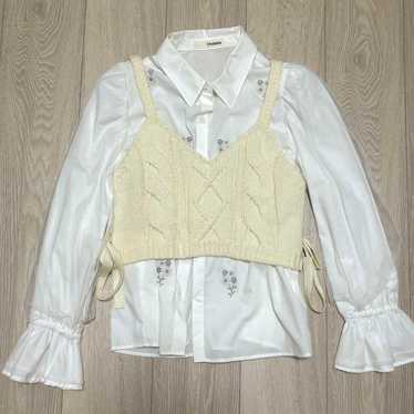 Cream-colored cable-knit vest with a white shirt … - image 1