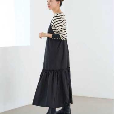 A black long one-piece dress in a camisole style (