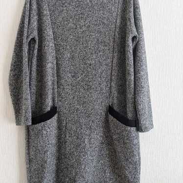 Grey long-sleeve knee-length dress.