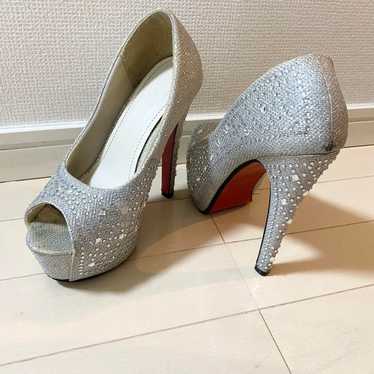 Silver open-toe pumps with rhinestones.