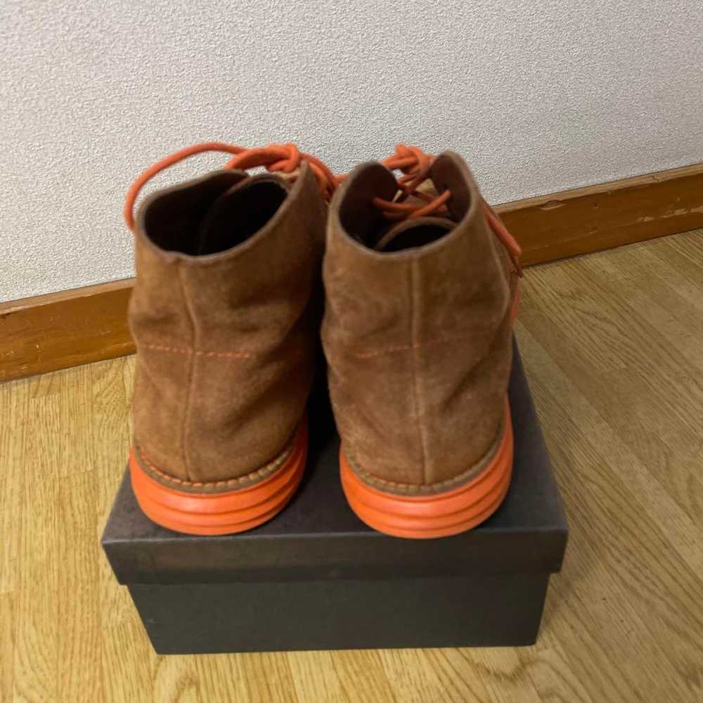 Brown suede chukka boots with orange laces. - image 2