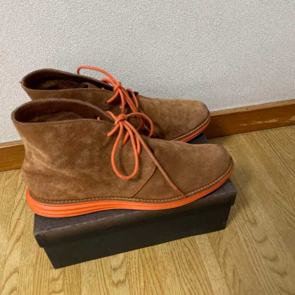 Brown suede chukka boots with orange laces. - image 3