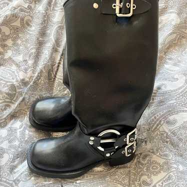 Black leather long boots with buckle.