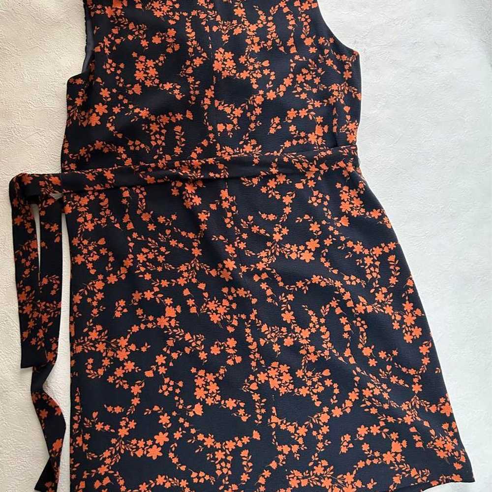 A black and orange floral sleeveless dress. - image 2