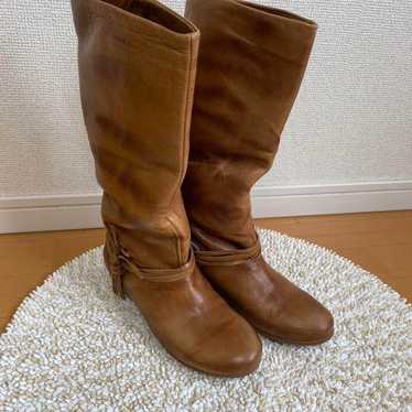 Brown leather long boots with belt.