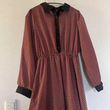 Red and black shirt dress with long sleeves.