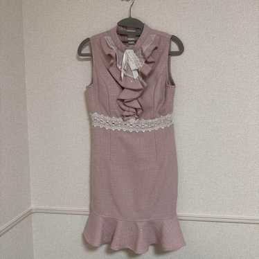 Light pink frilled dress, sleeveless.