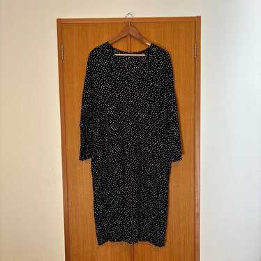 A long-sleeved dress with black and white polka do