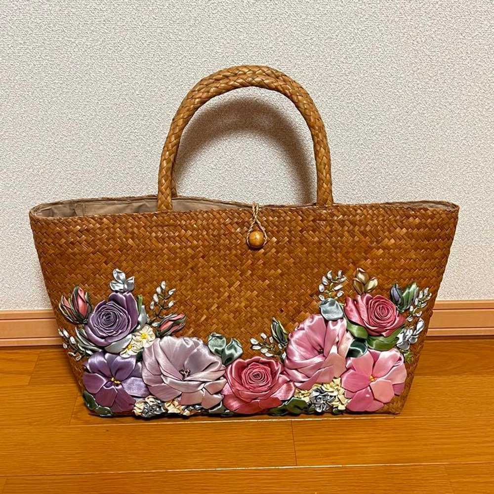 A basket bag embellished with flower embroidery. - image 1