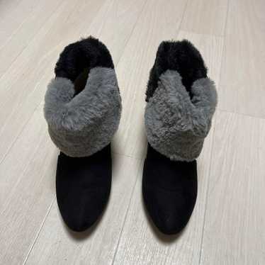 Black and gray mid-heel boots with fur trim.