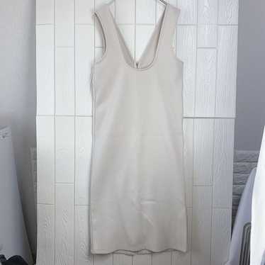 Beige sleeveless knee-length dress.