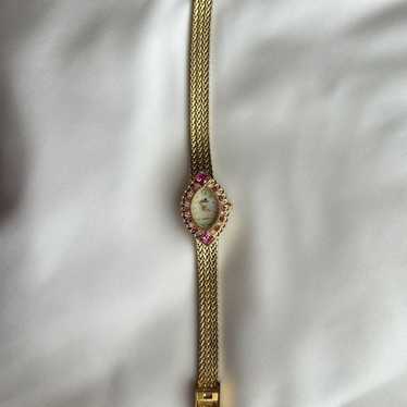 Gold watch with pink gemstones