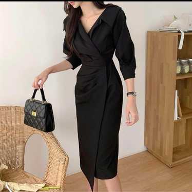 Black shirt dress, long sleeves.