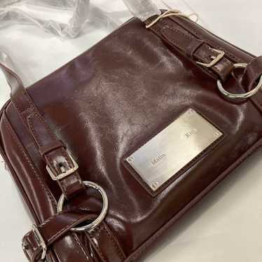 MUSINSA | MATIN KIM SIDE ZIPPER SHOULDER BAG IN DARK BROWN
