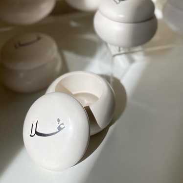 White Round Containers With Black Script - image 1