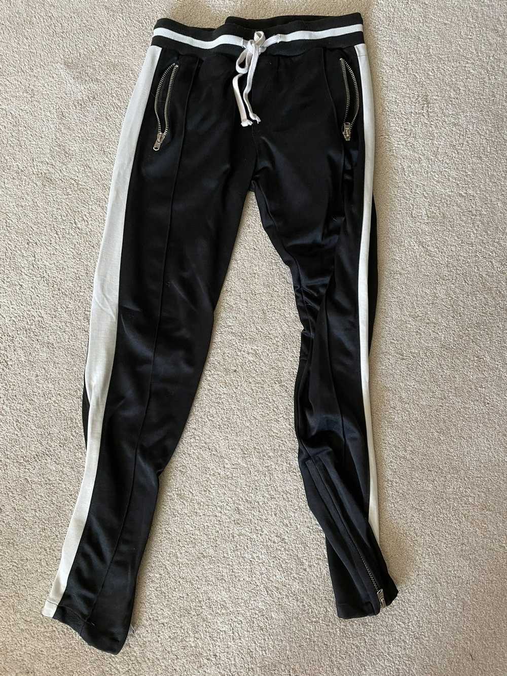mnml mnml track pants used and has a small hole