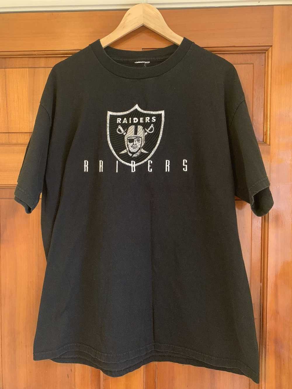 Oakland Raiders on an abraded steel texture T-Shirt by Movie