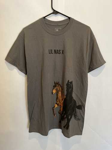 A Black Horse and a Cowboy with Blue Pants, Yellow Shirt and Big White Hat  — Two Graces, Art Books and Curios, Taos, NM