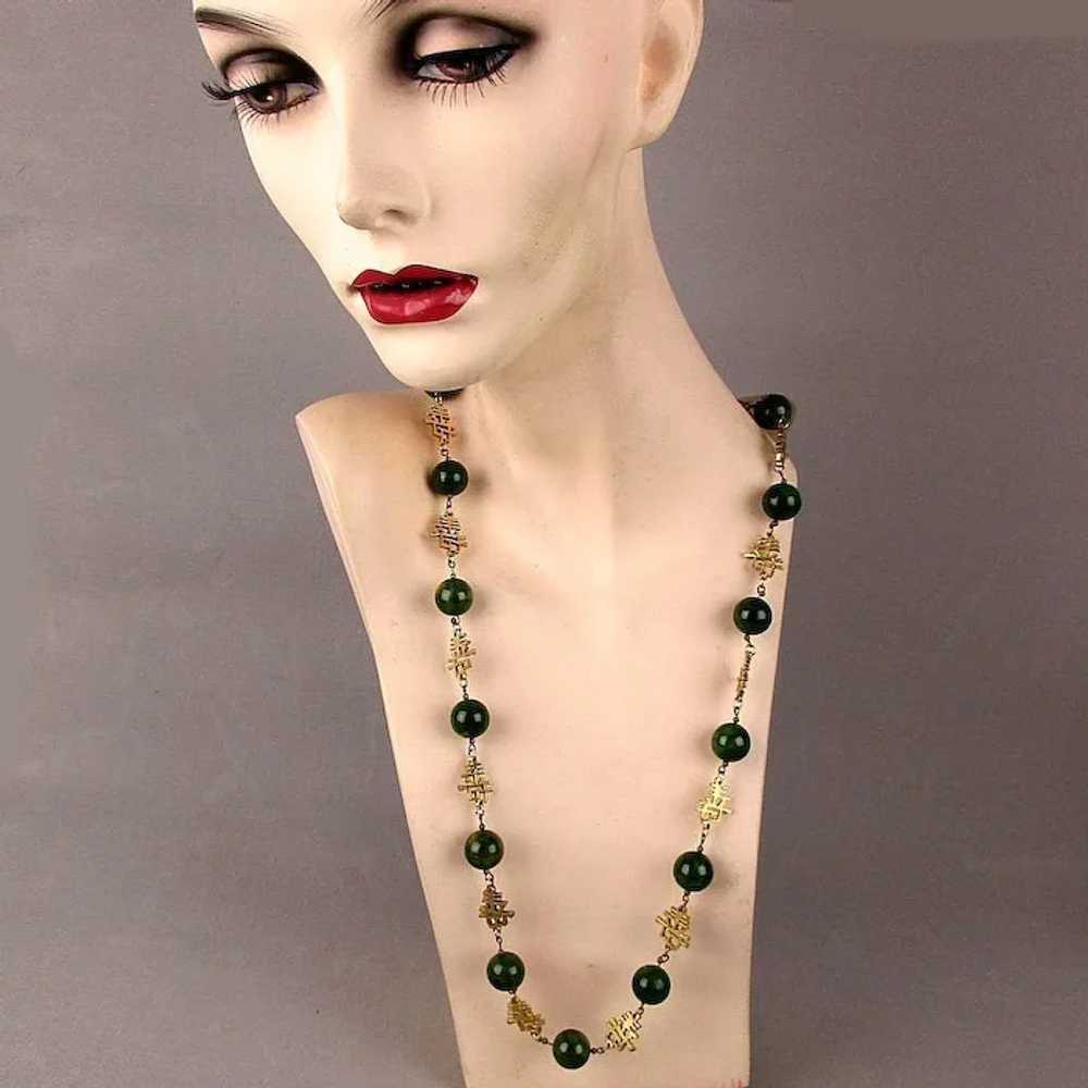 A CHANEL long necklace with black and green pearls, blac…