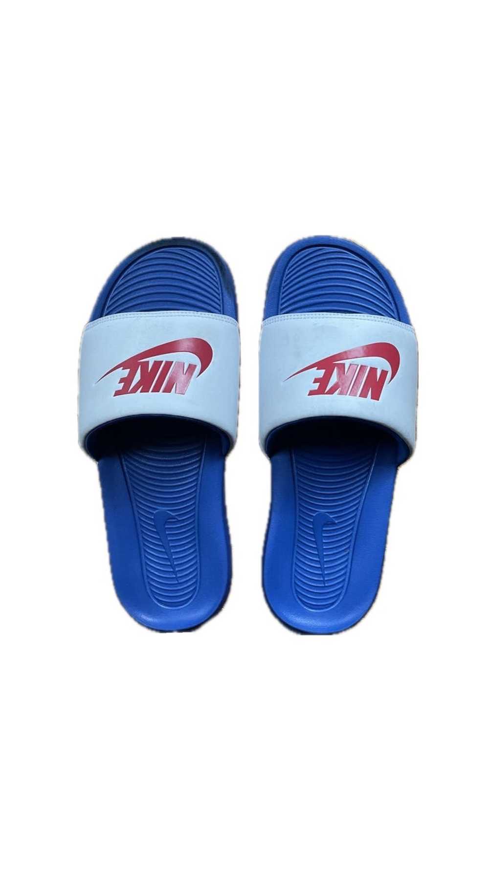 red and white fuzzy nike slides