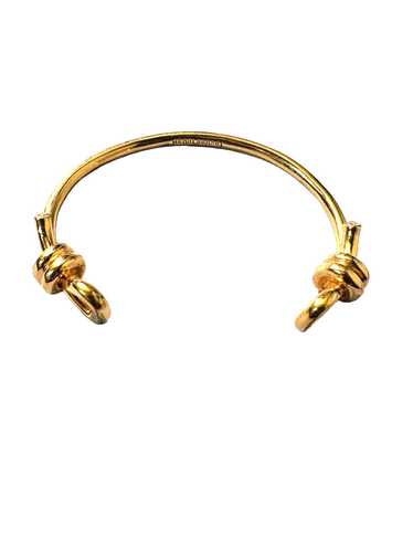 Beautiful Henri Bendel bronze bangle with knot det