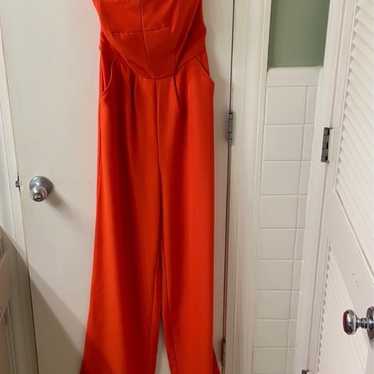 Orange strapless jumpsuit with front pockets