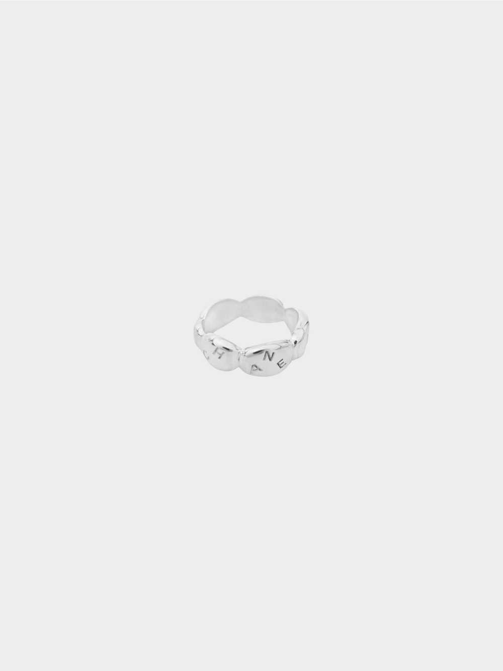 Chanel 1990s Silver Camellia Radis Logo Ring - image 1